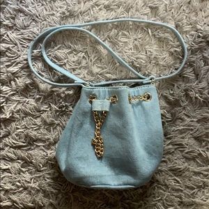 A denim blue crossbody bag